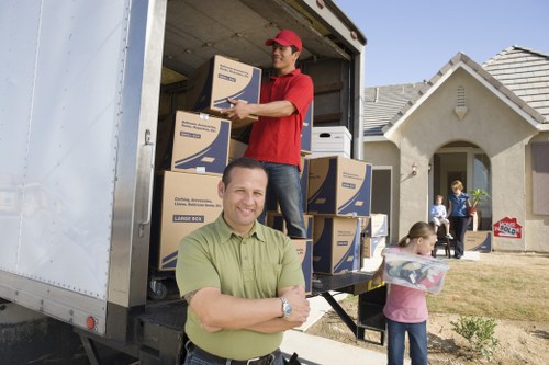 Local removal van handling household items and boxes in Eltham