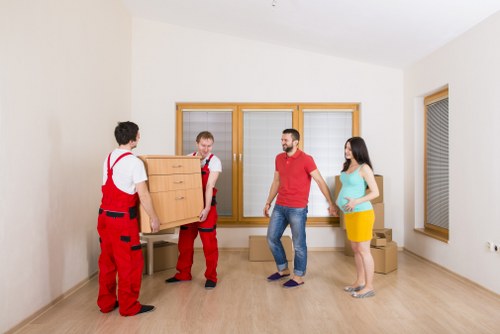 Team handling furniture during a house move in southeast London