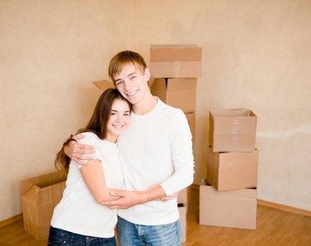 A moving team handling boxes and household items at a local property