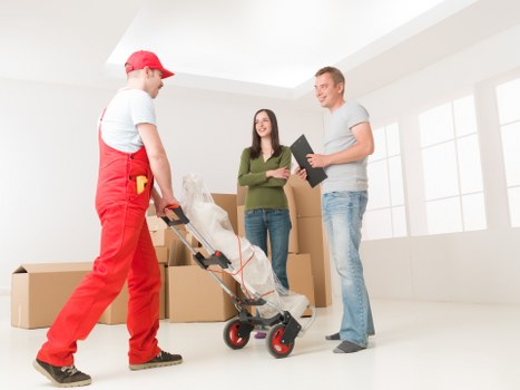 Van moving household items through a residential street